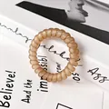Matte champagne gold spiral hair tie with a durable and flexible telephone wire design - Light Coffee
