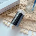 Black high-elasticity seamless hair ties set stored in a clear cylindrical jar - Black