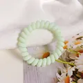 Light green spiral hair tie with a minimalist candy-colored elastic telephone wire design - Mint Green