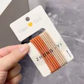 Set of high-elasticity hair ties in orange and beige tones on a branded card - Orange and Coffee