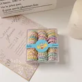 Colorful elastic baby hair ties in a clear square box with macaron shades - Bamboo Style / Bamboo Light Colors