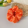 Vibrant orange satin hair scrunchie with a glossy finish and elegant pleated design - Orange Red