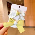 Green floral and solid knit bow hair clip set on a handmade display card for girls - Floral Bowknot Style / Grass Green