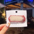 Plush knitted hair clip in deep red and cream dual-tone design on display card - Caramel color