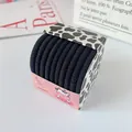 Lot d'élastiques à cheveux noirs à haute élasticité dans une boîte à motif de vache - Noir Style B