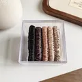 Set of 5 satin scrunchies in earth tones including black and bronze in a clear storage box - Dark Color