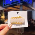 Cute ginger and cream wavy knitted bow hair clip on a white display card - Off-white Lace Trim