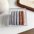 Set of 5 minimalist satin scrunchies in silver and bronze stored in a clear acrylic box - Blue Pink