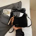 Chic black matte shoulder bag with oversized bow handle and colorful beaded tassel charm - With Pendant / Black