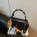 Glossy black vintage handbag with golden hardware and colorful wooden bead tassel - With Charm / Black