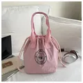 Rosa Thermo-Lunchtasche mit Kordelzug und Eichhörnchen-Logo auf weißem Sofahintergrund - Rosa