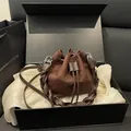 Brown suede bucket bag with twisted handle and drawstring, presented in a gift box set - Brown