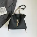 Black textured shoulder bag with golden logo, fringe detail and chain strap in variant - Black