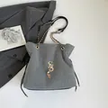 Gray glitter crossbody bag featuring gold chain strap and letter tassel detail - Gray