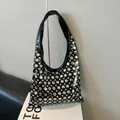 Fashionable black hobo bag with silver metallic studs and polished finish - Black