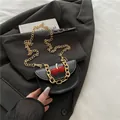 Black leather saddle bag with cherry charm and gold chain handle decoration - Black