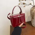 Deep burgundy patent leather box bag with gold hardware and dual zipper top handle - Red