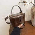 Deep brown patent leather box bag with gold-tone hardware and top handle strap - Brown