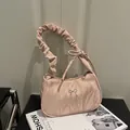 Pink marble-textured crescent underarm bag with pleated strap and silver bow detail - Pink