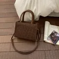 Deep brown leopard print handbag in matte finish with a crossbody strap and top handle - No Pendant / Brown