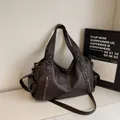 Dark brown dumpling tote bag with lychee texture and decorative zippers in a variant color - Coffee
