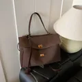 Minimalist dark brown suede tote bag with golden twist locks and versatile straps - Brown