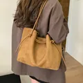 Caramel suede tote bag with drawstring closure and slim straps shown on a model - Single Bag / Brown