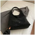 Minimalist black matte suede hobo tote bag with spacious interior for daily commute - Black