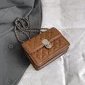 Chic brown quilted crossbody bag with silver chain strap and metal lock closure - Brown