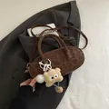 Chic dark brown leopard print baguette bag with a cute plush monster charm - Brown with Pendant