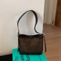 Large leopard print faux suede bucket bag with black leather straps and adjustable belt - Leopard Print