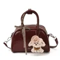 Retro burgundy boston bag in glossy finish with plush dog charm and ribbon detail - With Pendant / Burgundy