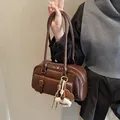 Vintage dark brown underarm bag with a gold buckle pocket and plush charm detail - With Charm / Coffee