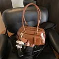 Vintage caramel leather underarm bag with decorative pockets and plush sheep pendant - With Charm / Brown