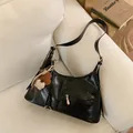 Glossy black hobo bag in wrinkled faux leather with decorative pendant charms - No Pendant / Black