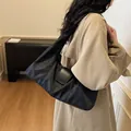 Lightweight black nylon shoulder bag with leather flap detail for daily commuting - Black