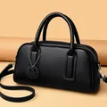 Black Boston bag in lychee pattern leather with double handles and smiley face tag - Black