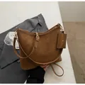 Brown vintage faux leather tote bag with matching coin purse on a grey blazer - Brown
