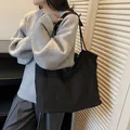 Minimalist black suede tote bag for women showing a large capacity slouchy shoulder design - Black