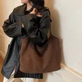 Minimalist brown suede tote bag with leather strap shown as a stylish shoulder bag - Coffee