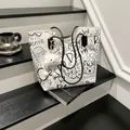 Graffiti print tote bag in white leather with black hand-drawn art and cloud pendant - With Pendant / White