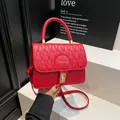Elegant red quilted shoulder bag with gold Fashion text and wave pattern finish - Red