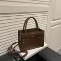 Brown faux leather handbag with buckle detail and adjustable shoulder strap - Coffee