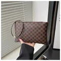 Close-up of brown long wallet with M-pattern print and unique metal circular wrist strap - Style M Coffee