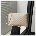Detail of beige monogram long wallet with zipper and wrist strap in a stylish indoor setting - Rick Morty McDonald White