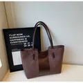 Dark brown tote bag in a sleek material patchwork design with elegant braided leather detail - Coffee