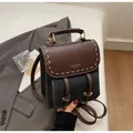 Vintage kleiner Rucksack aus Leder in Braun und Schwarz mit goldenen Beschlägen - Schwarz