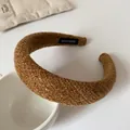 Brown woven thick sponge headband with handmade label shown on a ceramic cup - Brown