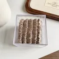 Set of 5 champagne satin pleated hair scrunchies displayed in a clear acrylic storage box - Khaki