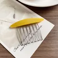Elegant yellow resin hair comb with ten silver metal teeth on artistic background - Yellow